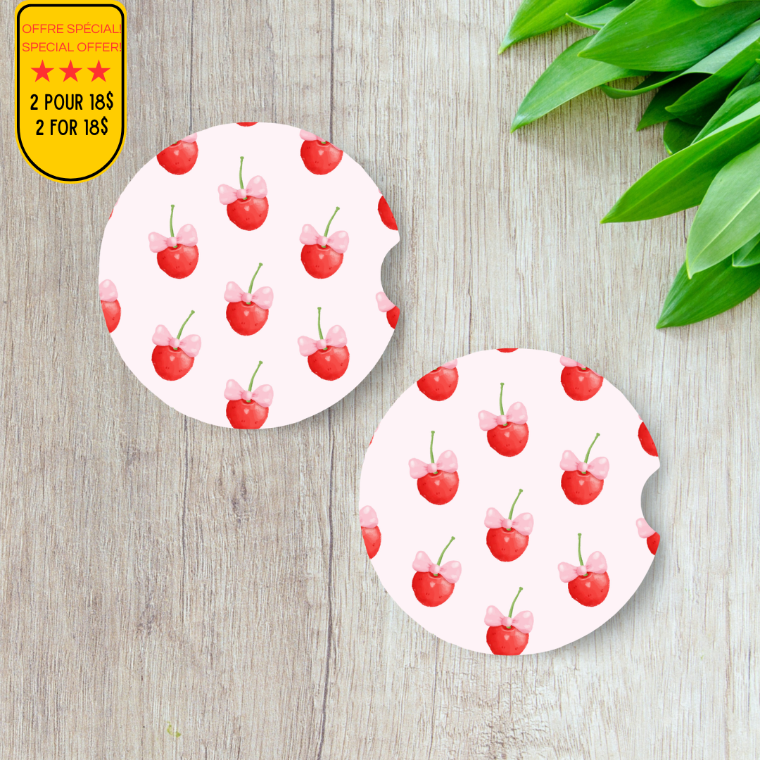 Duo de sous-verres pour voiture motif cerises rouges sur fond pastel.