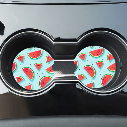 Duo de sous-verres melon d'eau installés dans les porte-gobelets d'une voiture.